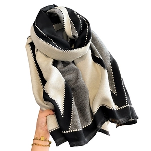 Soft black and white geometric patterned scarf with fringe details for autumn and winter