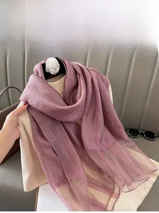 Detailed view of purple silk blend scarf with metallic stripes and translucent edges