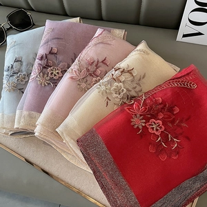 Detailed view of multi-color embroidered silk blend scarves featuring fine floral needlework