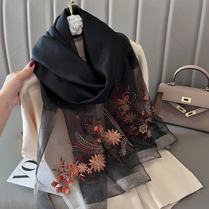Elegant black silk blend scarf featuring orange floral embroidery and sheer mesh details
