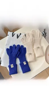 Detailed view of ribbed knit gloves in navy and beige with premium woven texture