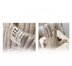 Detailed macro view of beige knit gloves showing the woven label and thumb opening design
