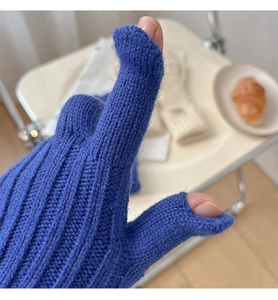 Close-up of blue knitted gloves with touchscreen openings on the thumb and index finger