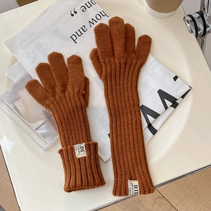 Detailed knit texture and brand label on caramel touch screen winter gloves