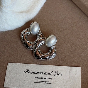 Quilted silver hoop earrings with faux pearl center in a classic geometric hollow design