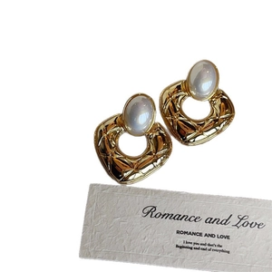 Classic quilted gold hoop earrings with oval pearl inlay in a minimalist setting