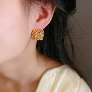 Elegant gold-plated geometric hollow stud earrings with sparkling cubic zirconia on model