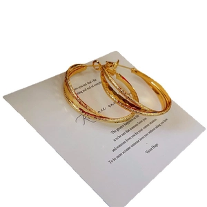 Frosted and polished gold double hoop earrings with a chic interlocking design