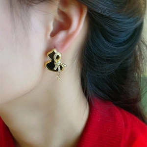 Exquisite gold gourd stud earrings with black enamel and micro-set bowknot detail