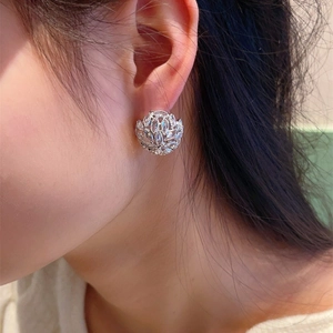 Elegant silver flower cluster earrings with marquise crystals worn on ear for women