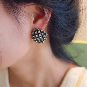 Detail of vintage French style gold-plated square stud earring with crystal rhinestones