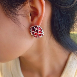 Close-up of red pearl mesh earrings worn by model showing vintage hollow grid design