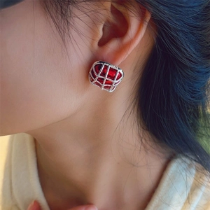 French vintage red grid pearl earrings with geometric cutout design on model's ear