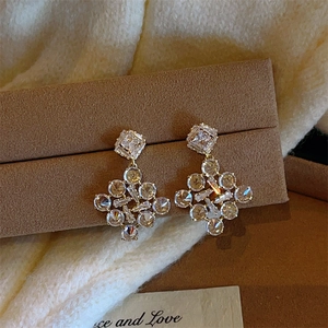 Elegant gold-plated snowflake drop earrings with sparkling cubic zirconia in a geometric design