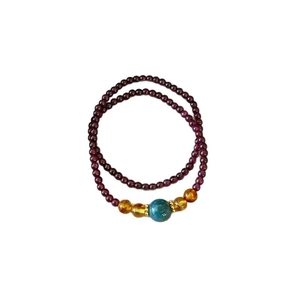 Double-layer garnet beaded bracelet with a blue centerpiece bead and gold accents