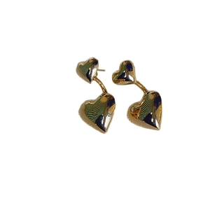 Elegant gold double heart-shaped stud earrings featuring a minimalist layered metal design