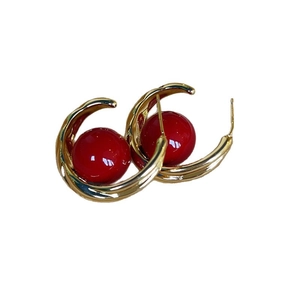 Fashionable gold C-shaped hollow hoop earrings with large polished red pearl accents