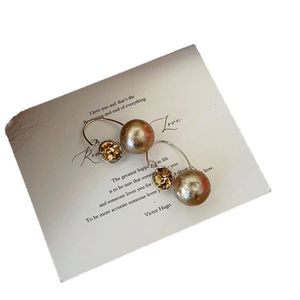 French vintage champagne crystal earrings with 10mm golden pearl drops on white background