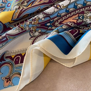 Detail showing paisley bohemian print on silky fabric with elegant hemmed edges