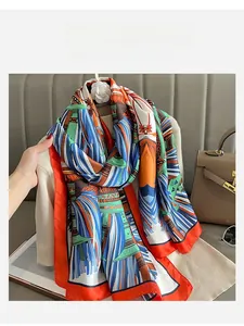 Detailed close-up of retro geometric patterned silk scarf with bright orange borders