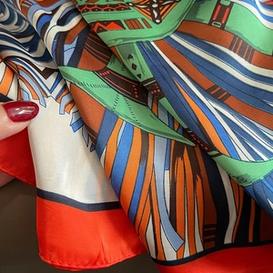 Detailed view of multicolor geometric silk scarf showing fine stitching and smooth texture