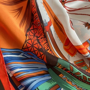 Macro detail of high-quality silk scarf showing intricate geometric patterns and glossy texture