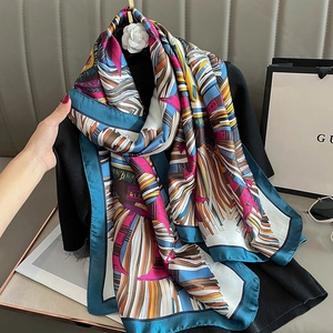 Elegant vintage patterned silk scarf with colorful abstract totem design on black top