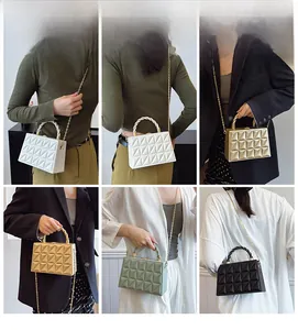Quilted box bag shown in white, gold, green, and black with chain strap and handle
