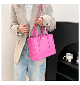 Hot pink faux leather tote bag styled with a blazer and jeans for a smart casual look