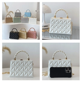 Detailed view of geometric quilted handbag texture with metal chain and top handle