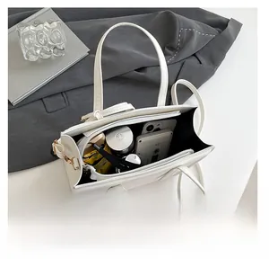 Top view of white tote bag interior showing multiple compartments and center zipper pocket
