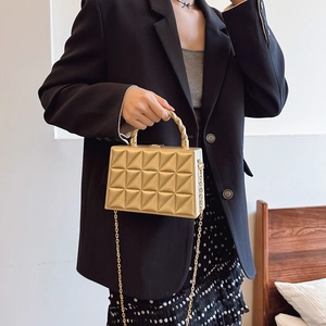 Champagne gold quilted box bag with a spiral metal handle and sleek chain strap for women