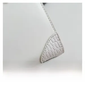 Detailed close-up showing high-quality white faux crocodile skin texture and precision stitching