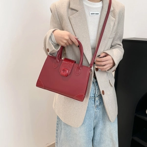 Red crocodile pattern square tote bag with crossbody strap shown with fashion model