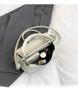 Top view of cream white lychee leather handbag showing interior space for essentials