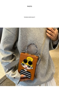 Detail of tan leather box bag with cartoon girl patch and silk scarf handle