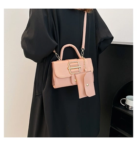 Pink crossbody bag set featuring gold rectangular buckle and lychee leather texture