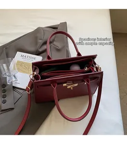 Detailed interior view of the burgundy tote bag with gold lock and wide compartment