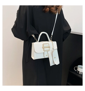Detailed view of white lychee texture shoulder bag with mini pouch and gold hardware