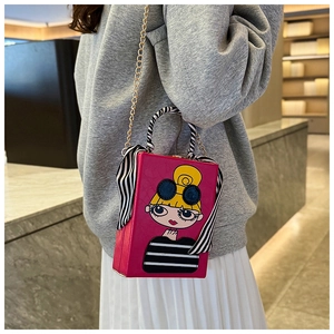 Detail of fuchsia box evening bag with fashion girl print and silk scarf handle
