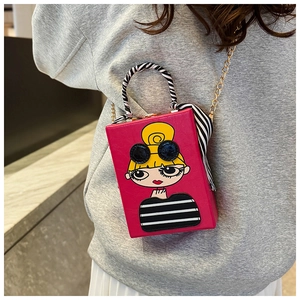 Detail of fuchsia box clutch featuring cartoon girl illustration and zebra scarf handle