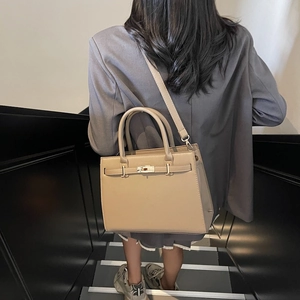 Beige Kelly style handbag with metal twist lock and detachable crossbody strap