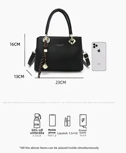 Detailed view of black litchi grain tote bag dimensions 23x16x13cm with gold hardware