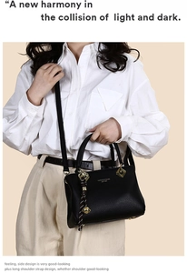 Detail of black lychee grain leather tote bag with gold charm and adjustable shoulder strap
