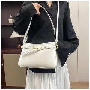 Sac fourre-tout chic en cuir blanc avec boucle dorée porté par un mannequin