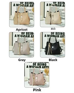 Five minimalist bucket bags in beige, white, grey, black, and pink with striped charms