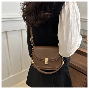 Brown vintage leather saddle bag with gold metal buckle and adjustable shoulder strap