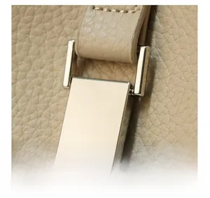 Close-up of premium light gold hardware and lychee grain leather on the shoulder bag