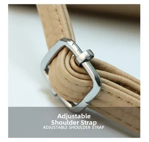 Detail of adjustable shoulder strap with silver buckle on beige leather bucket bag