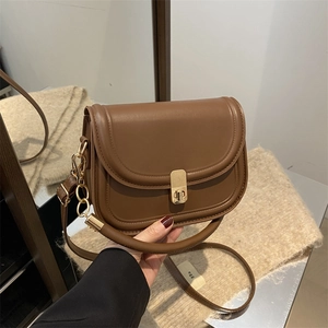 Classic brown leather small square bag with gold metal clasp and adjustable strap